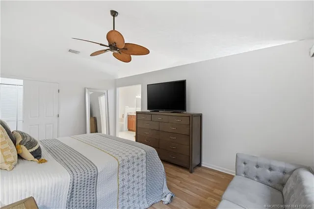a bathroom with a granite countertop double vanity sink and a mirror