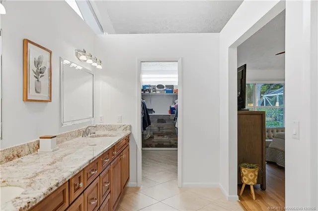 a view of a porch with chairs and potted plants