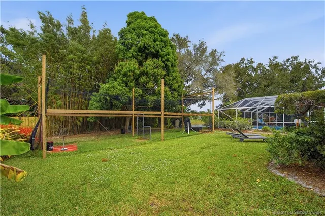 an aerial view of a house with a yard and lake view
