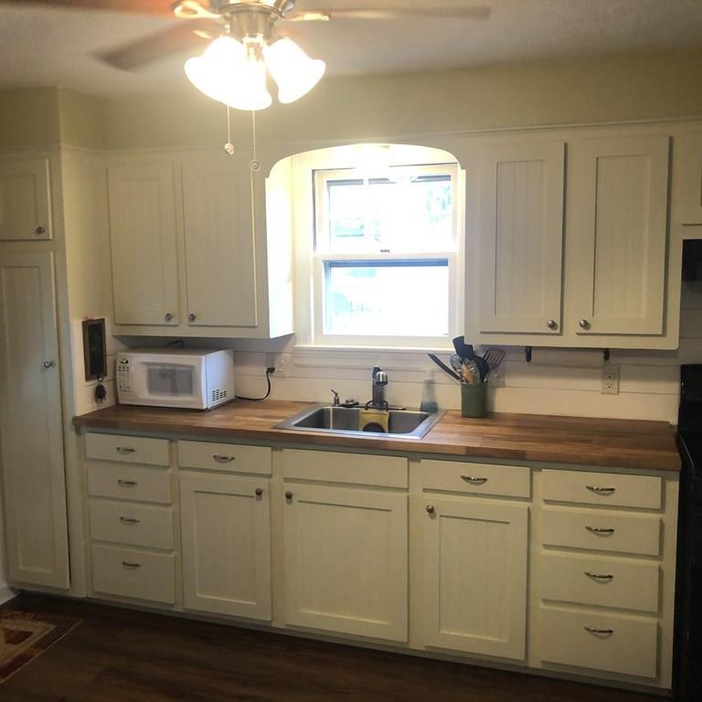 107 Winton Street Springfield, MA 01118 - Photo 10 of 39 a kitchen with cabinets appliances a sink and a window