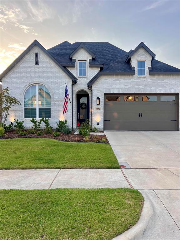 1228 Emilia Road Fate, TX 75087 - Photo 1 of 31 a front view of house with yard and green space