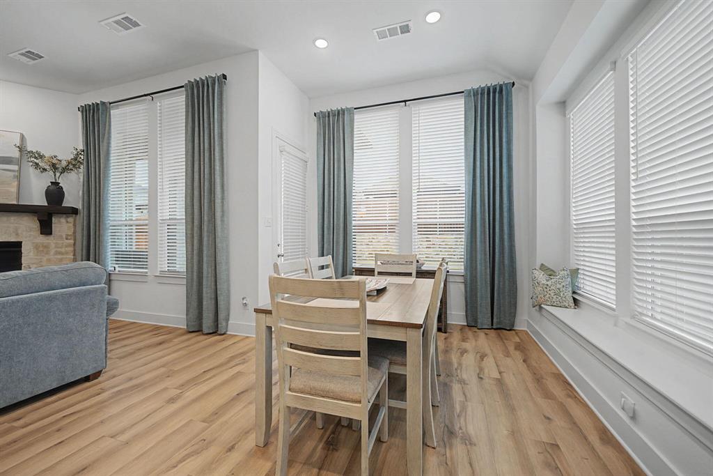 1228 Emilia Road Fate, TX 75087 - Photo 13 of 31 a living room with furniture a large window and wooden floor