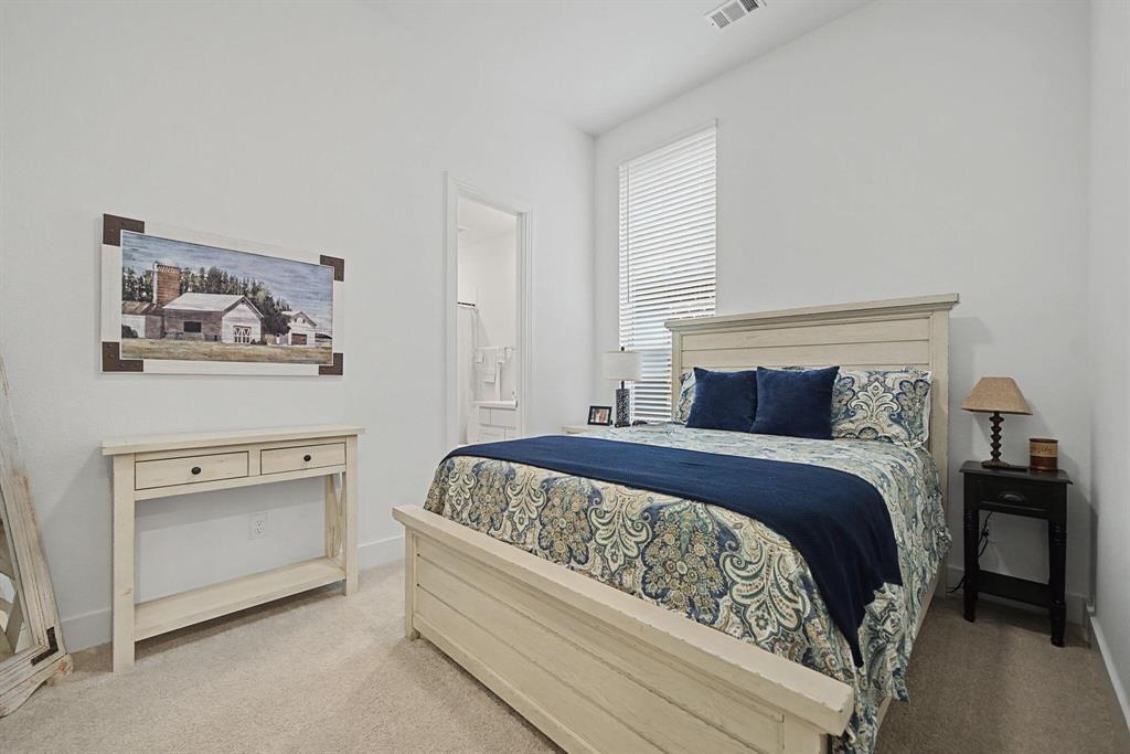 1228 Emilia Road Fate, TX 75087 - Photo 19 of 31 a bedroom with a bed and a painting on the wall