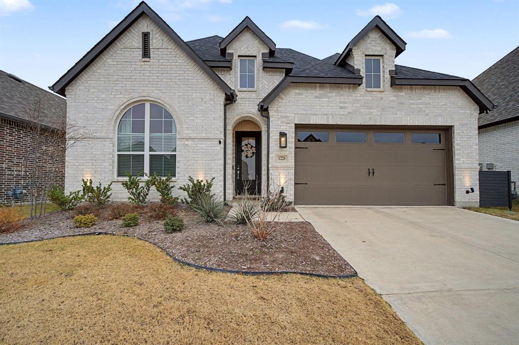 1228 Emilia Road Fate, TX 75087 - Photo 2 of 31 a front view of a house with a yard and garage