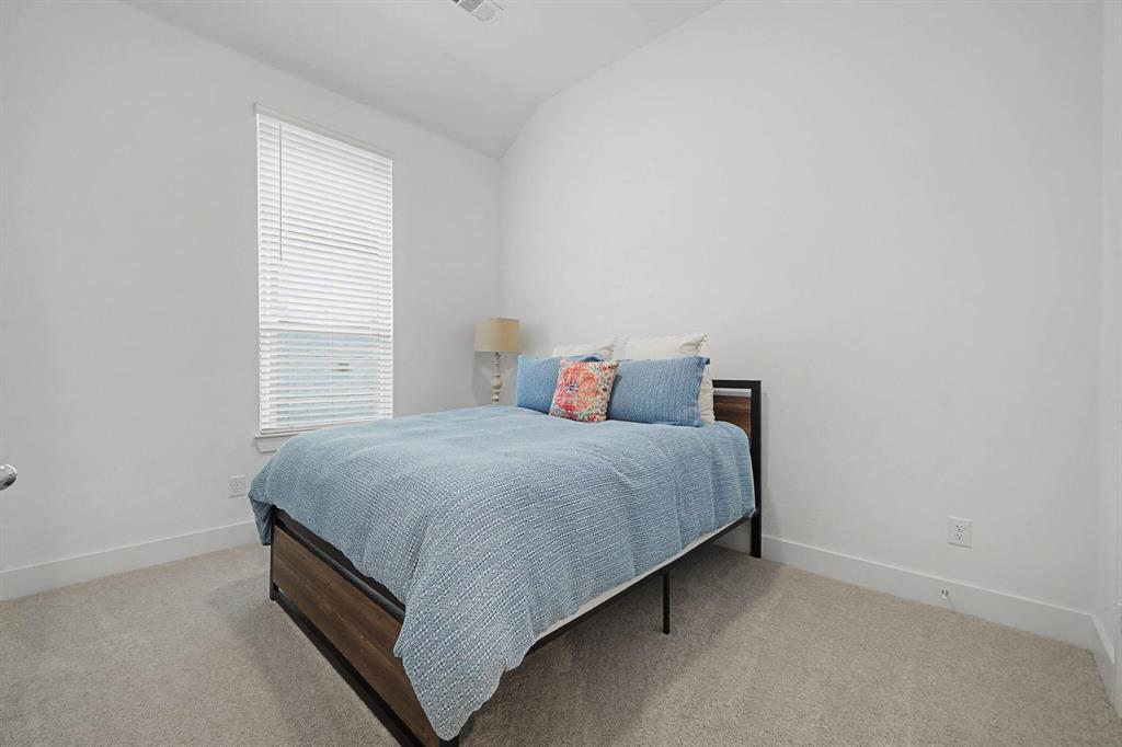 1228 Emilia Road Fate, TX 75087 - Photo 21 of 31 a bed sitting in a bedroom next to a window