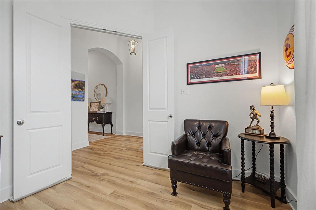 1228 Emilia Road Fate, TX 75087 - Photo 26 of 31 a living room with furniture and a wooden floor