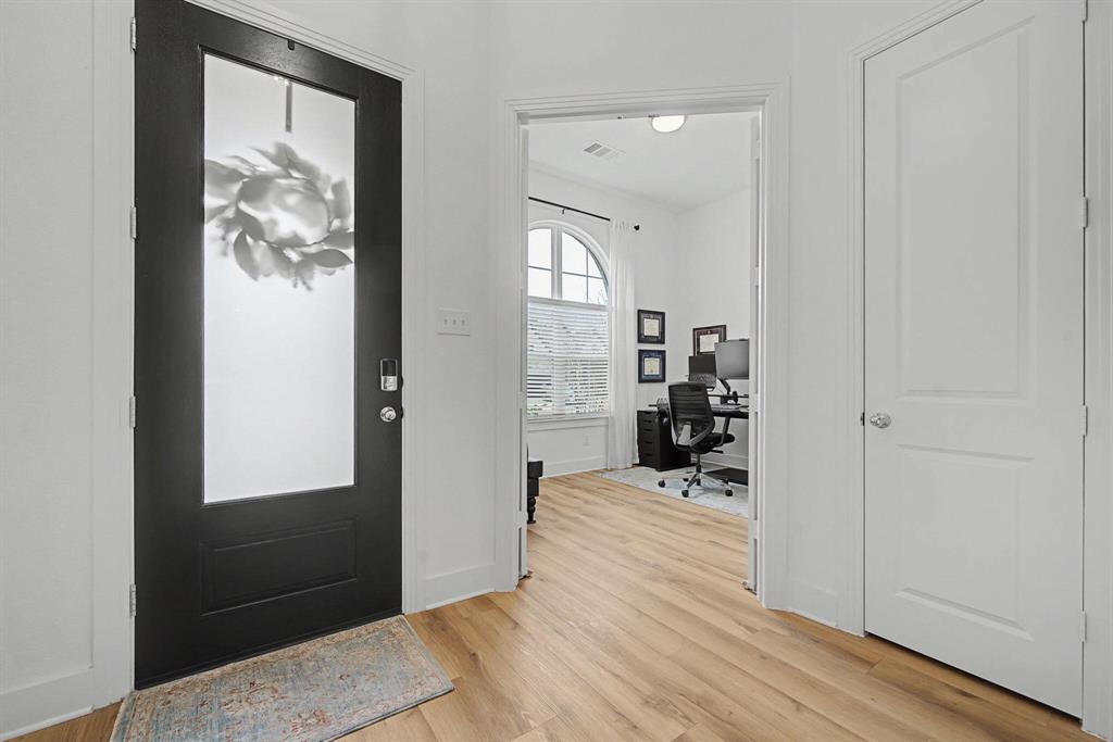 1228 Emilia Road Fate, TX 75087 - Photo 27 of 31 a view of a hallway with wooden floor and a living room
