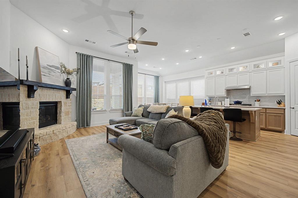 1228 Emilia Road Fate, TX 75087 - Photo 4 of 31 a living room with furniture and a fireplace