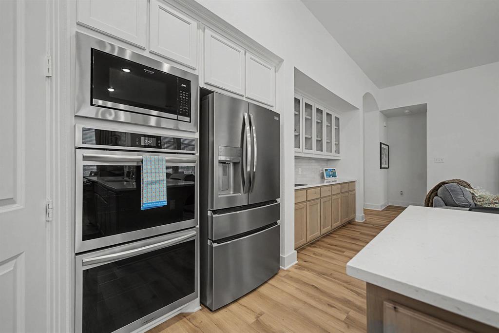 1228 Emilia Road Fate, TX 75087 - Photo 9 of 31 a kitchen with stainless steel appliances a stove a microwave and a refrigerator