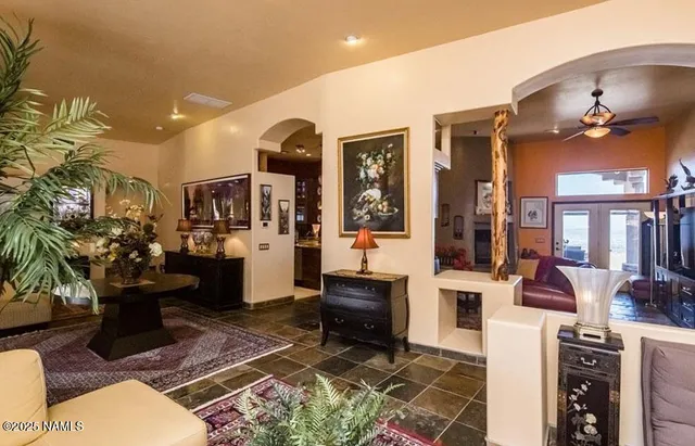 a living room with furniture a rug and a chandelier