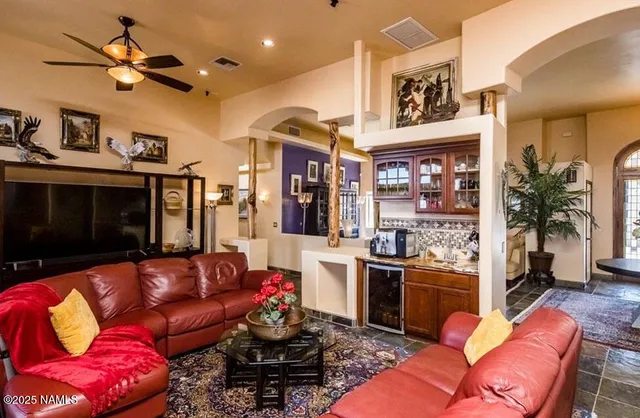 a living room with furniture kitchen view and a fireplace