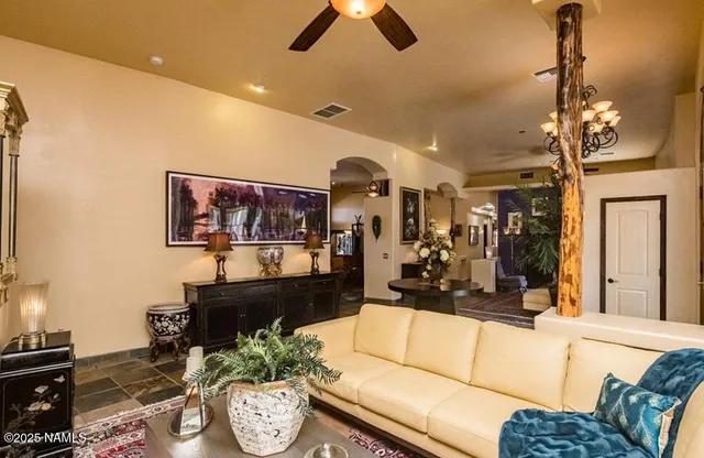 a living room with furniture and a chandelier