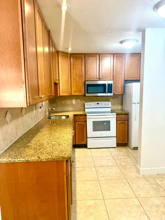 a kitchen with a stove a sink and a refrigerator