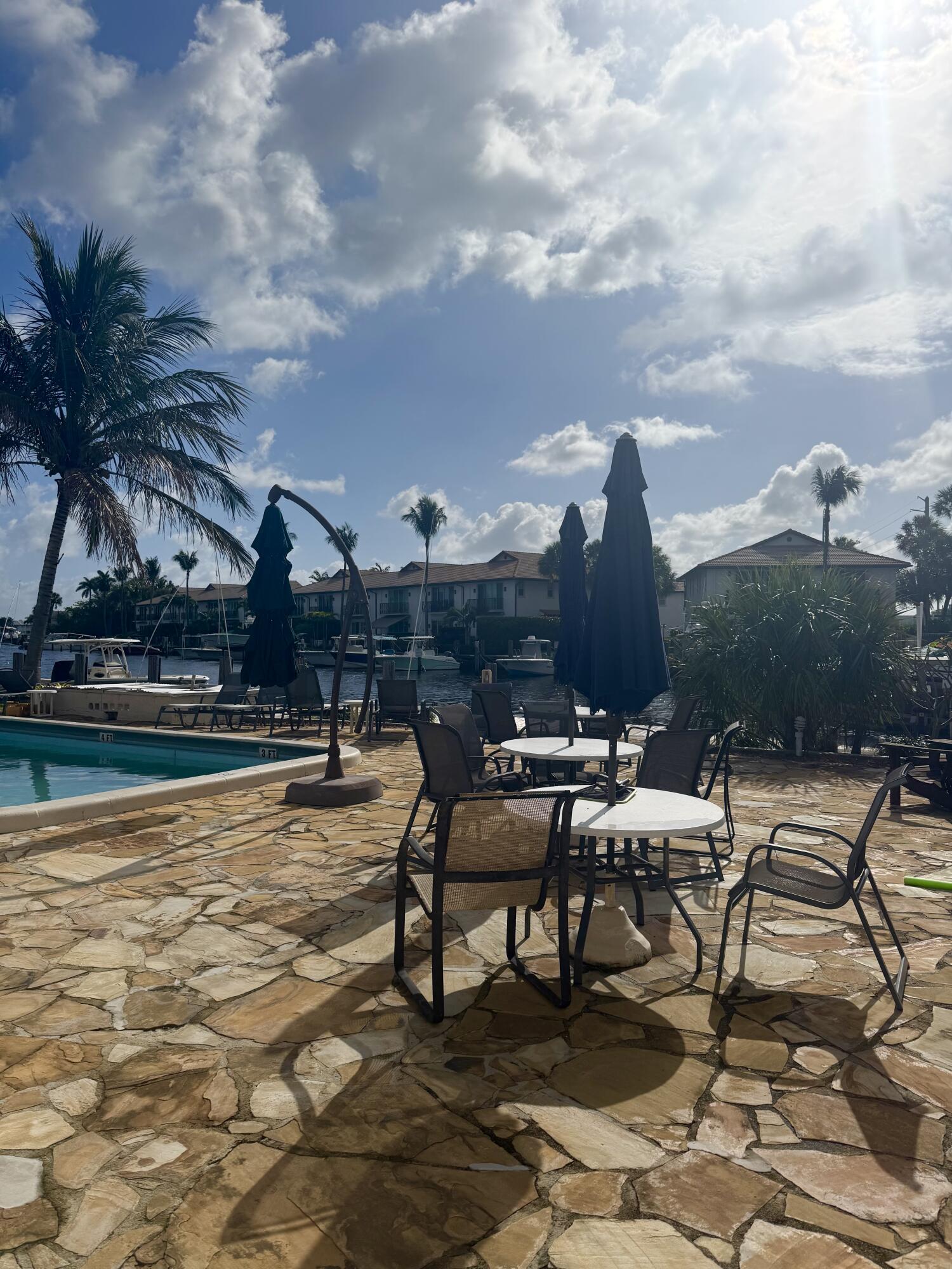199 East McNab Road, Unit 109 Pompano Beach, FL 33060 - Photo 16 of 17 a view of a swimming pool with lounge chairs