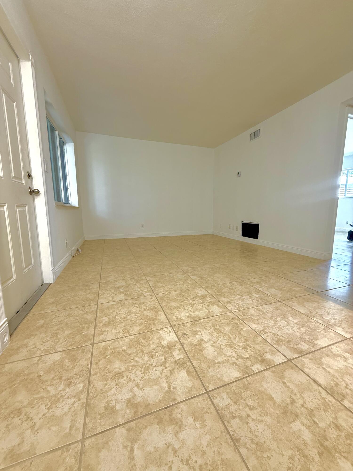 199 East McNab Road, Unit 109 Pompano Beach, FL 33060 - Photo 5 of 17 a view of an empty room with windows
