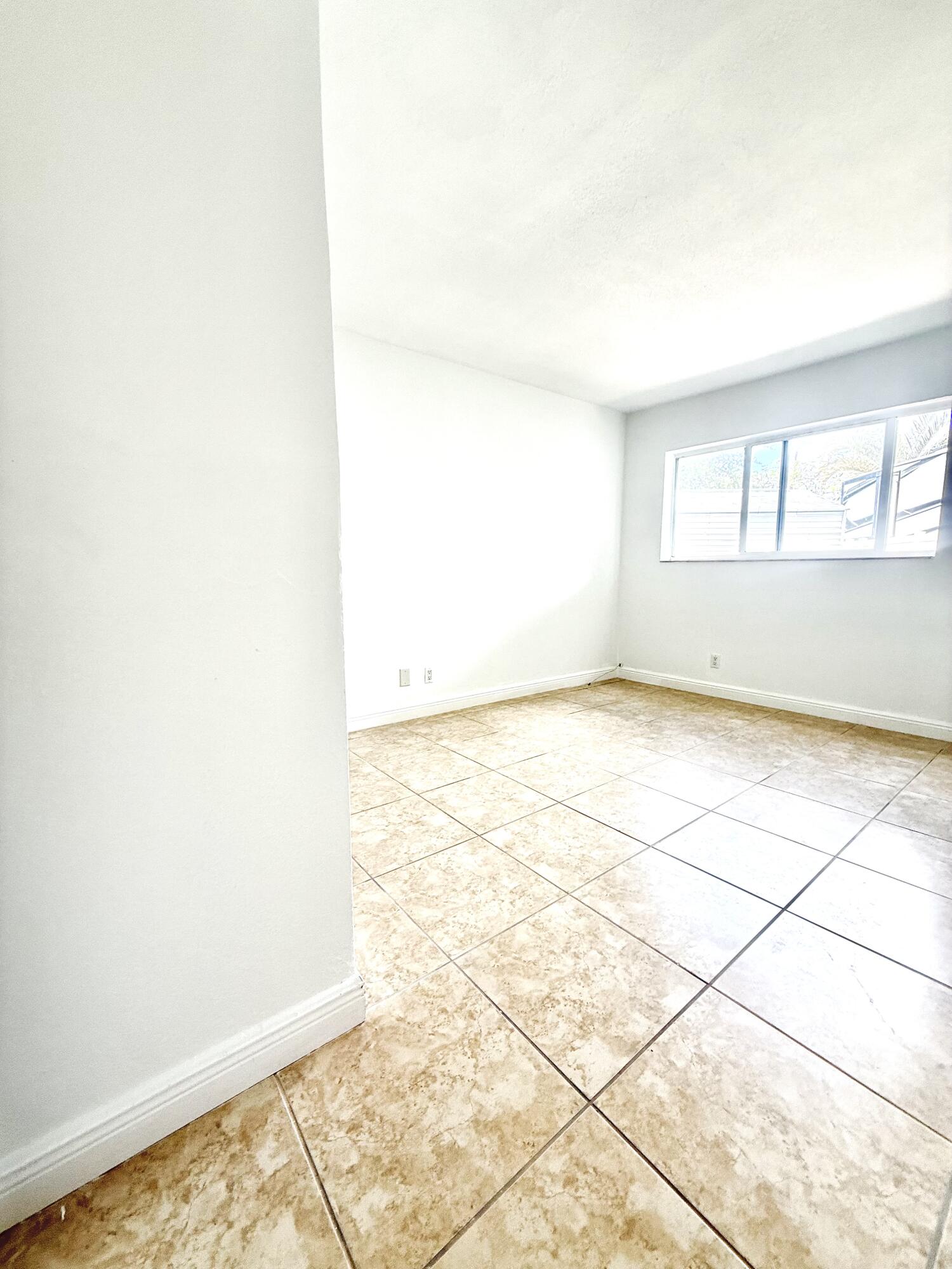 199 East McNab Road, Unit 109 Pompano Beach, FL 33060 - Photo 6 of 17 an empty room with windows