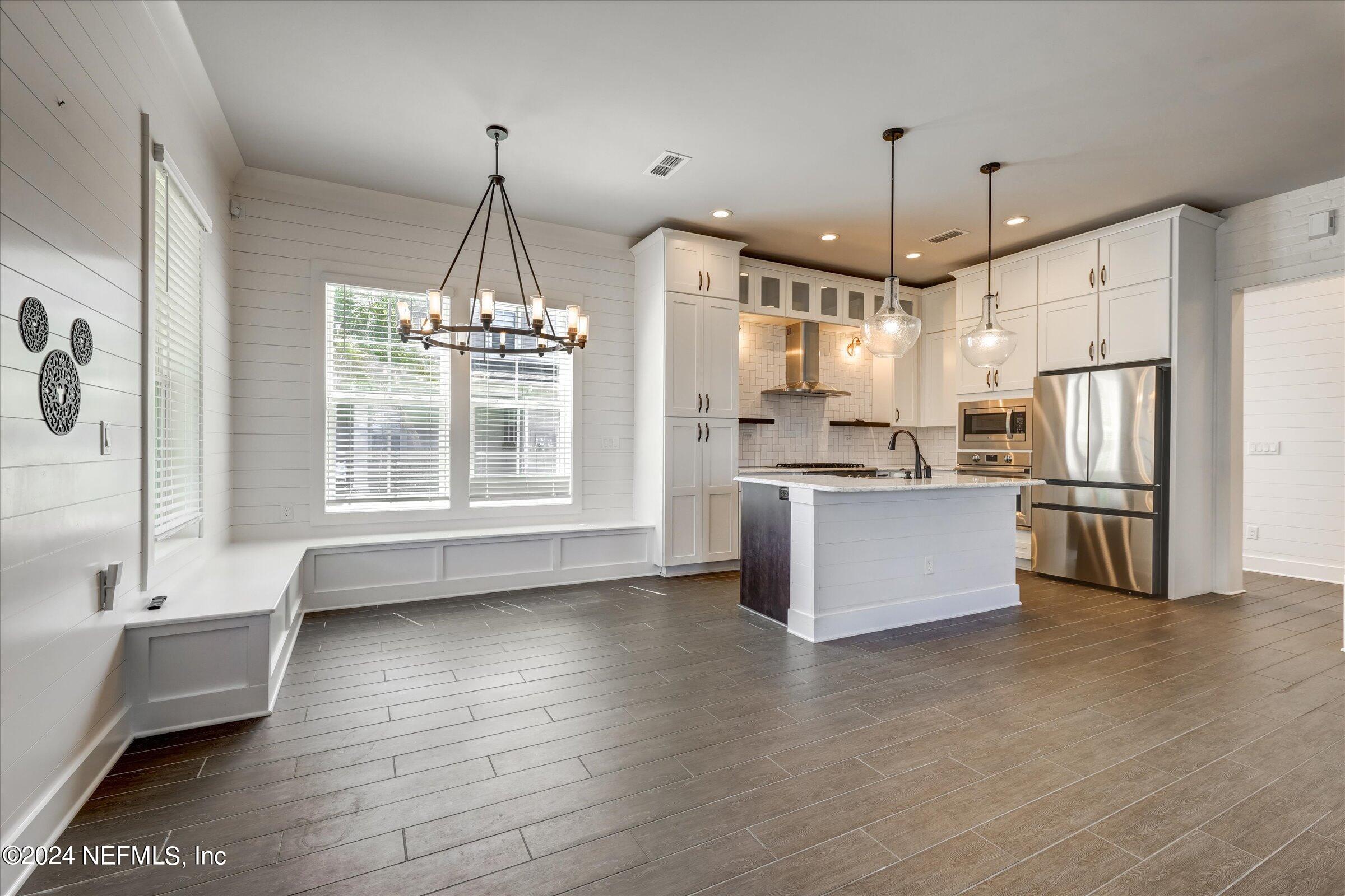 75 Bronson Parkway St. Augustine, FL 32095 - Photo 14 of 55 a kitchen with stainless steel appliances granite countertop a refrigerator a sink a stove and a wooden floors