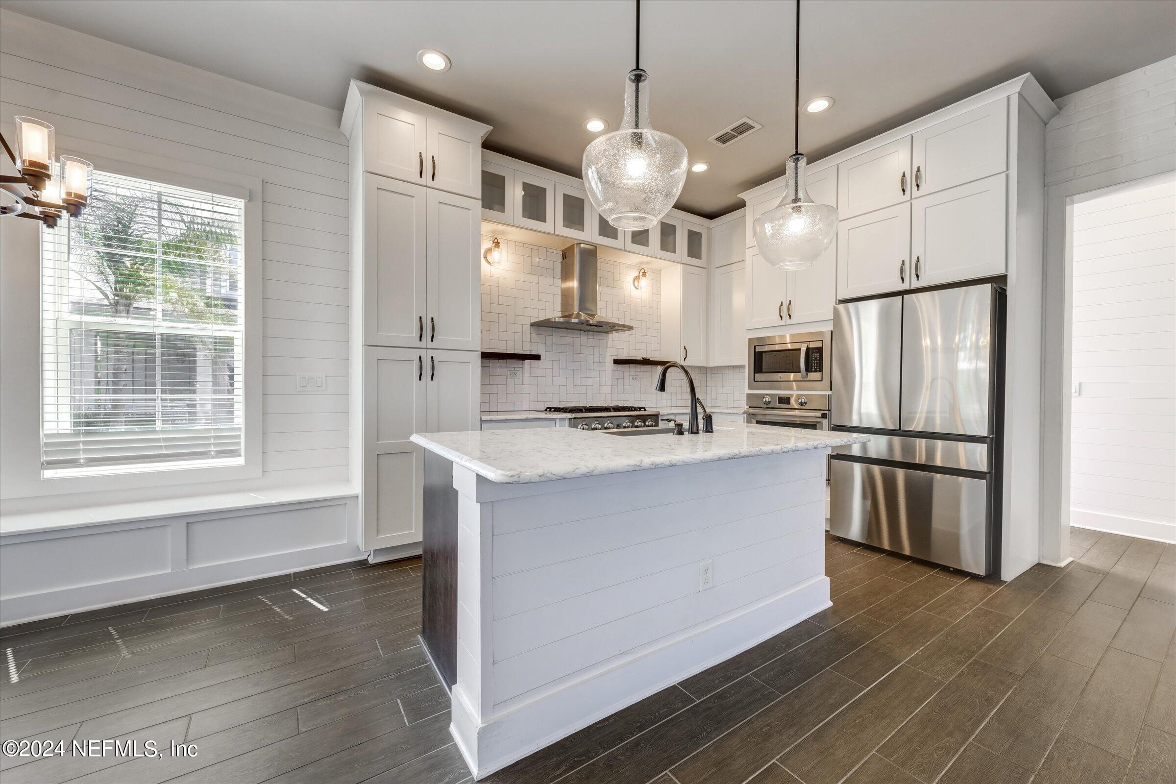75 Bronson Parkway St. Augustine, FL 32095 - Photo 15 of 55 a kitchen with stainless steel appliances kitchen island granite countertop a refrigerator a oven a stove and a refrigerator