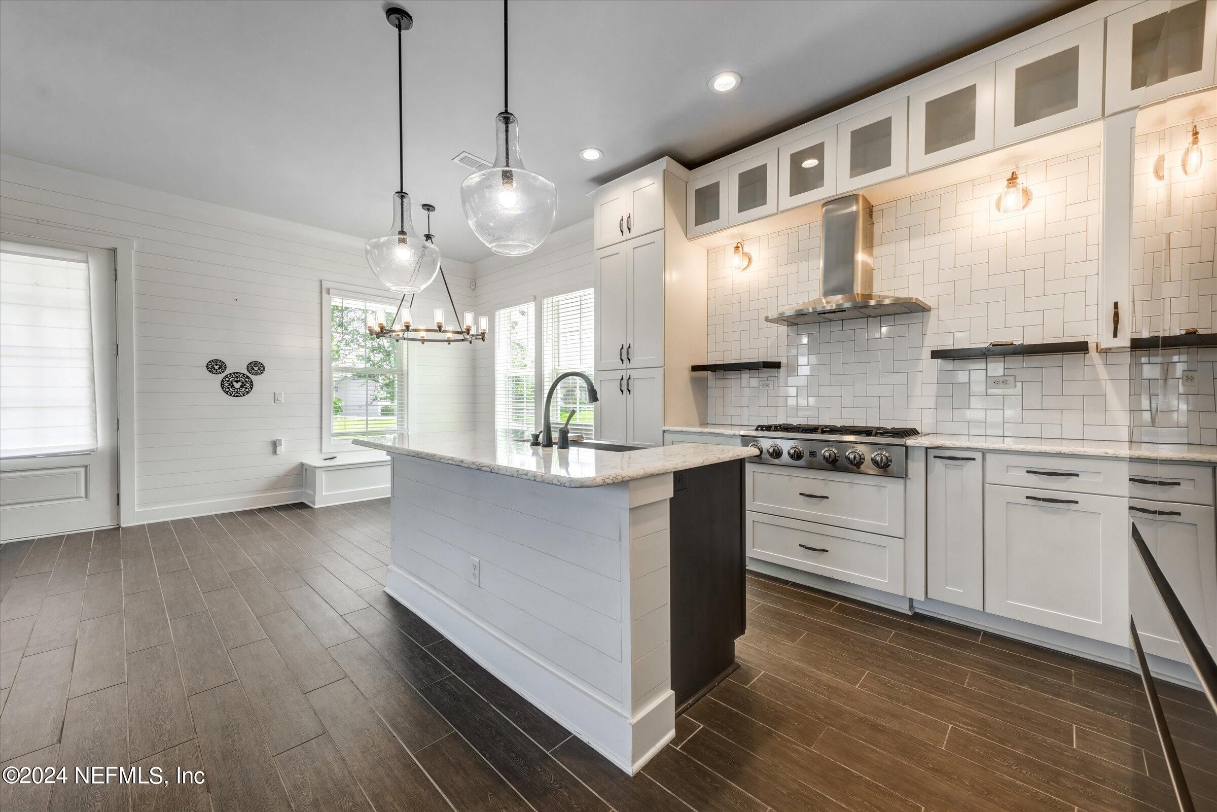 75 Bronson Parkway St. Augustine, FL 32095 - Photo 16 of 55 a kitchen with stainless steel appliances kitchen island granite countertop a stove a sink and a refrigerator