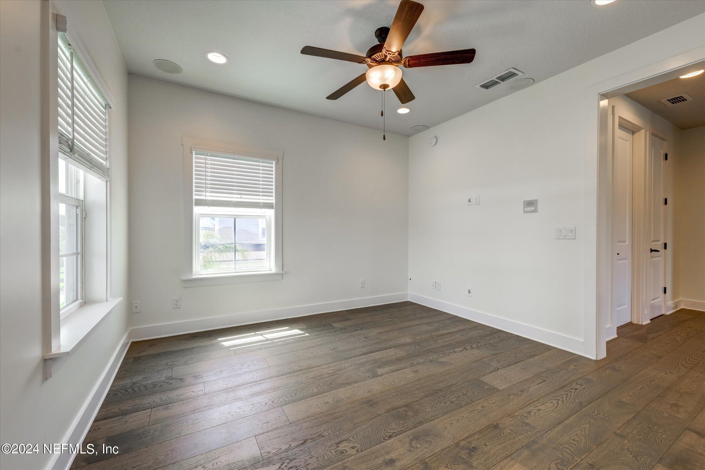 75 Bronson Parkway St. Augustine, FL 32095 - Photo 35 of 55 an empty room with wooden floor and windows