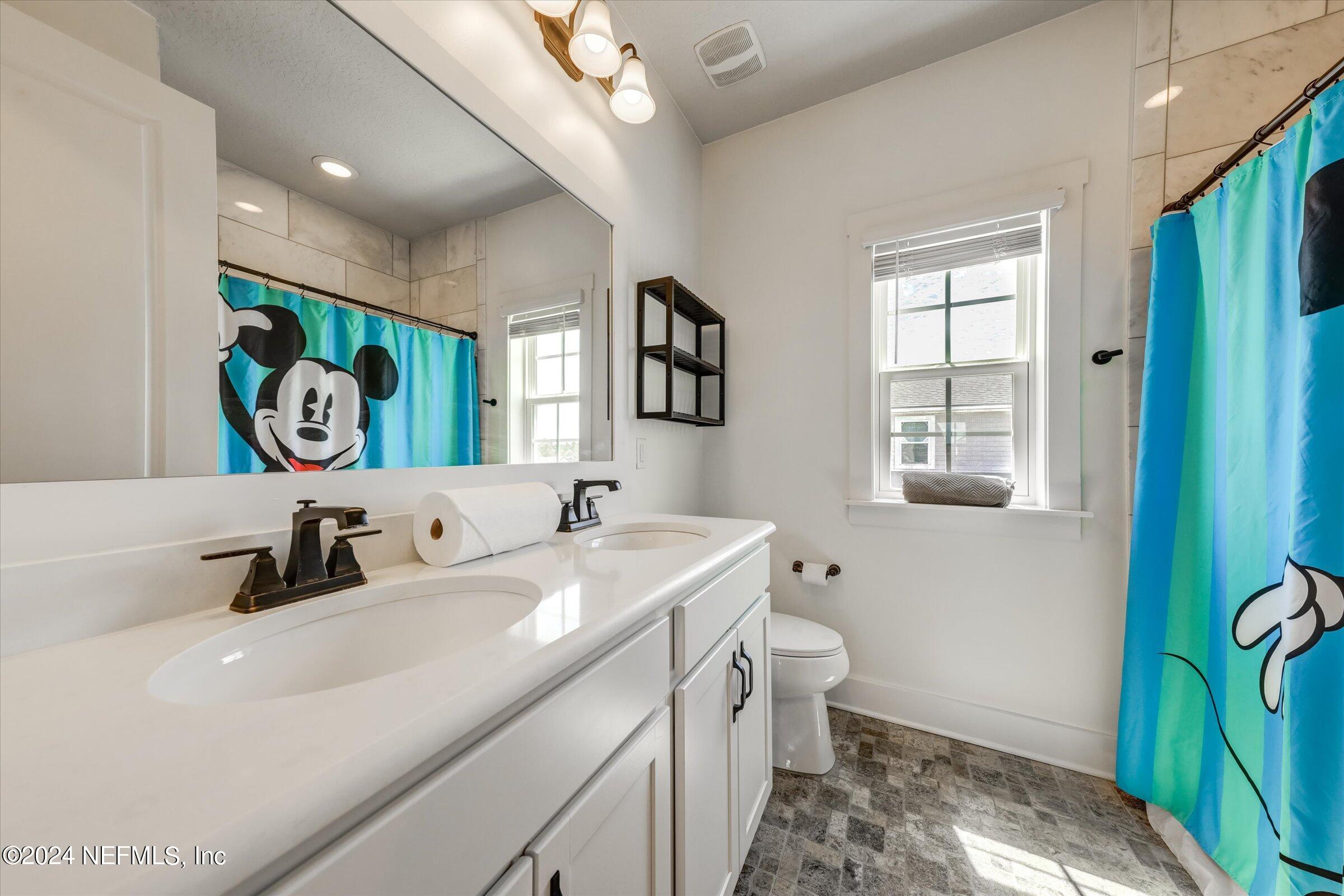 75 Bronson Parkway St. Augustine, FL 32095 - Photo 42 of 55 a bathroom with a sink a toilet and a mirror