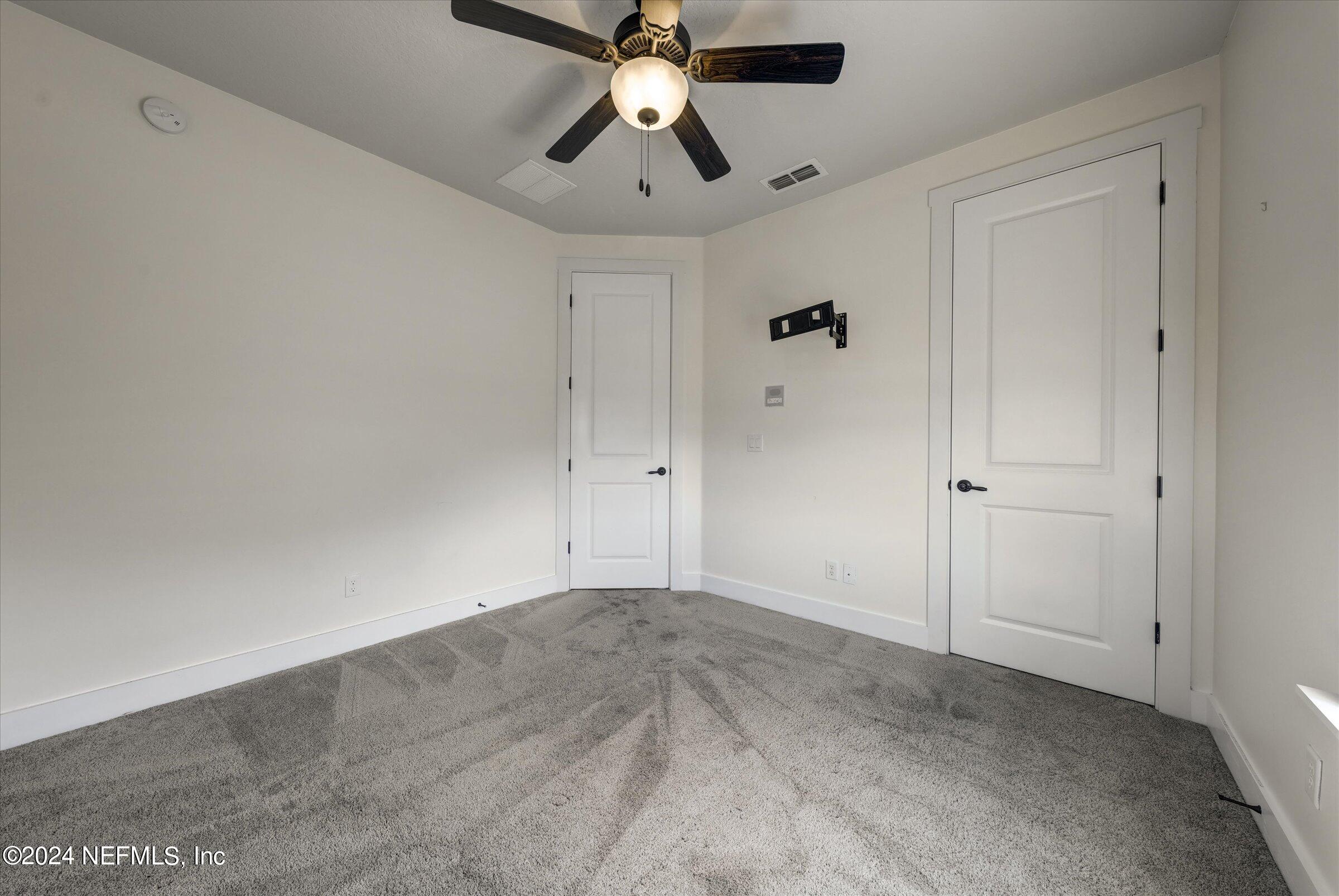 75 Bronson Parkway St. Augustine, FL 32095 - Photo 44 of 55 an empty room with closet and a chandelier fan