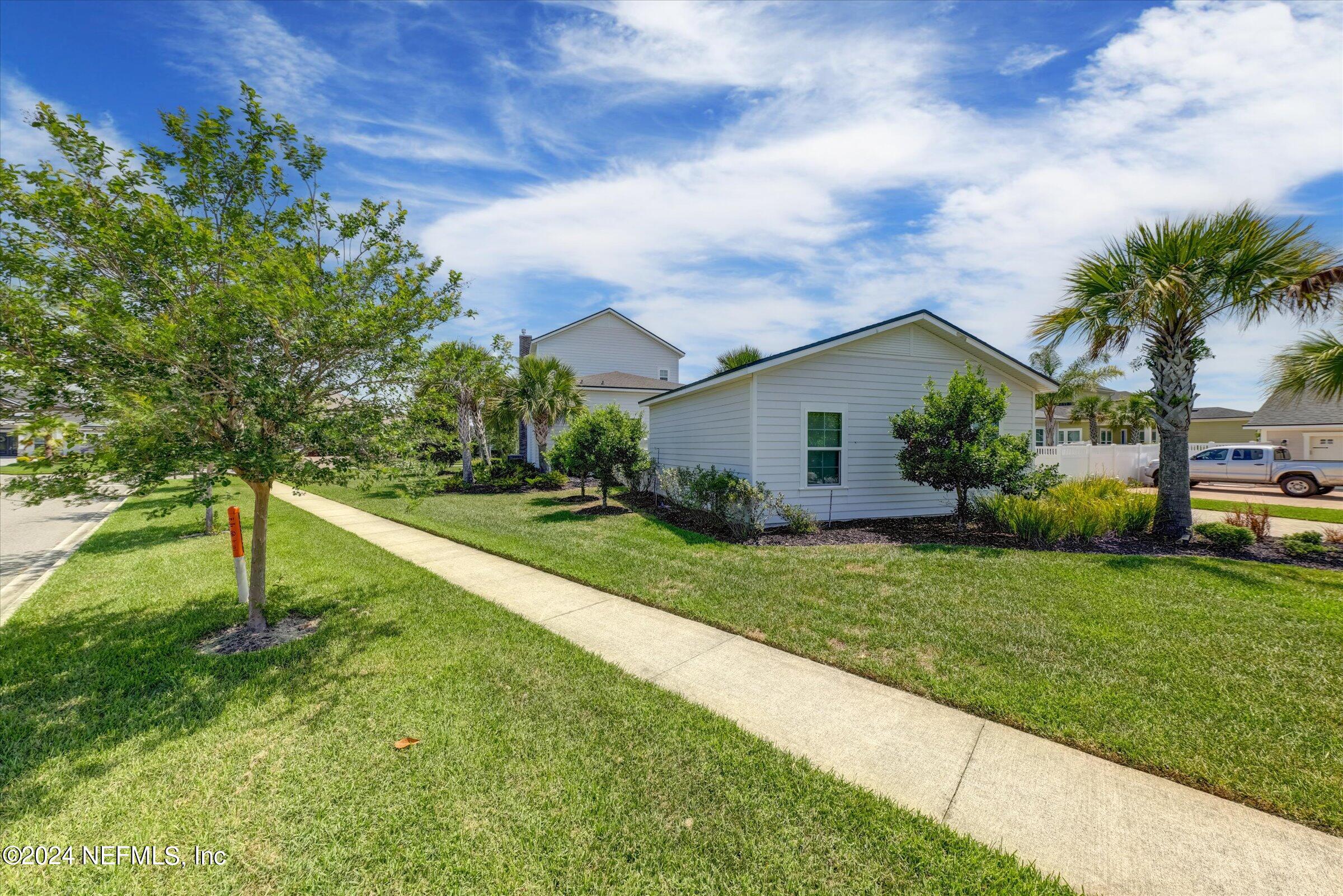75 Bronson Parkway St. Augustine, FL 32095 - Photo 55 of 55 a backyard of a house with plants and palm tree