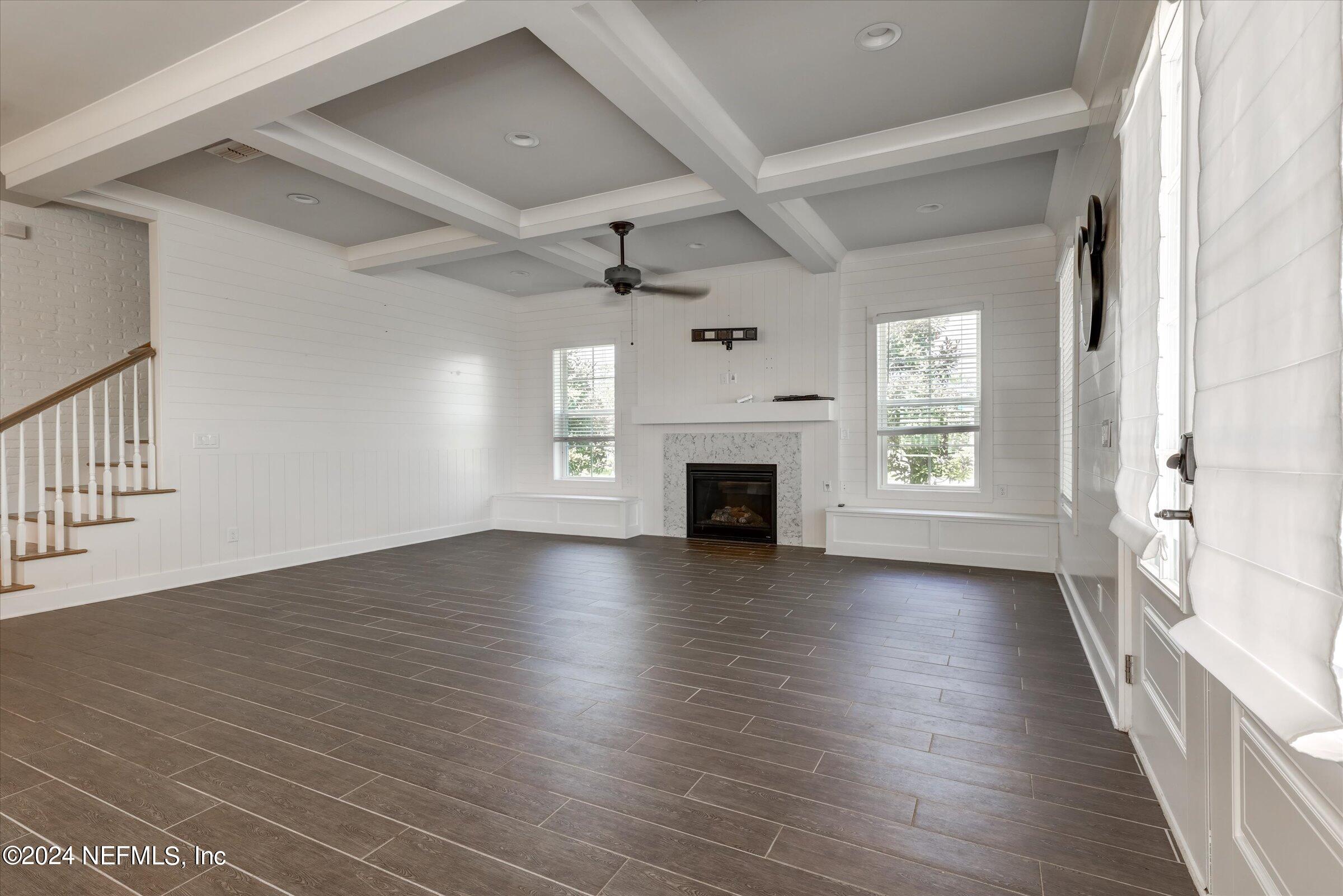 75 Bronson Parkway St. Augustine, FL 32095 - Photo 10 of 55 an empty room with wooden floor fireplace and windows