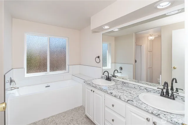 a view of an empty room with closet and a window