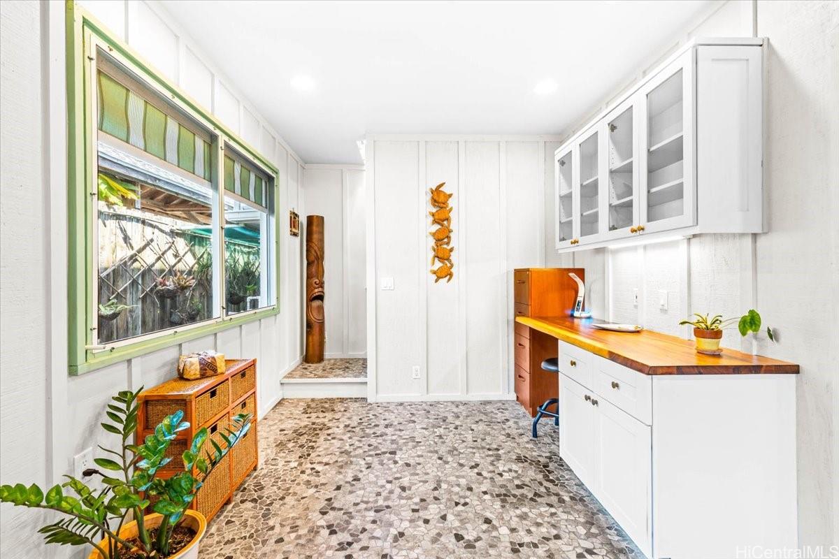 465 Kawailoa Road, Unit C Kailua, HI 96734 - Photo 12 of 25 Perfect office or study space leading to primary suite w/ colorful orchids hanging on the fence outside