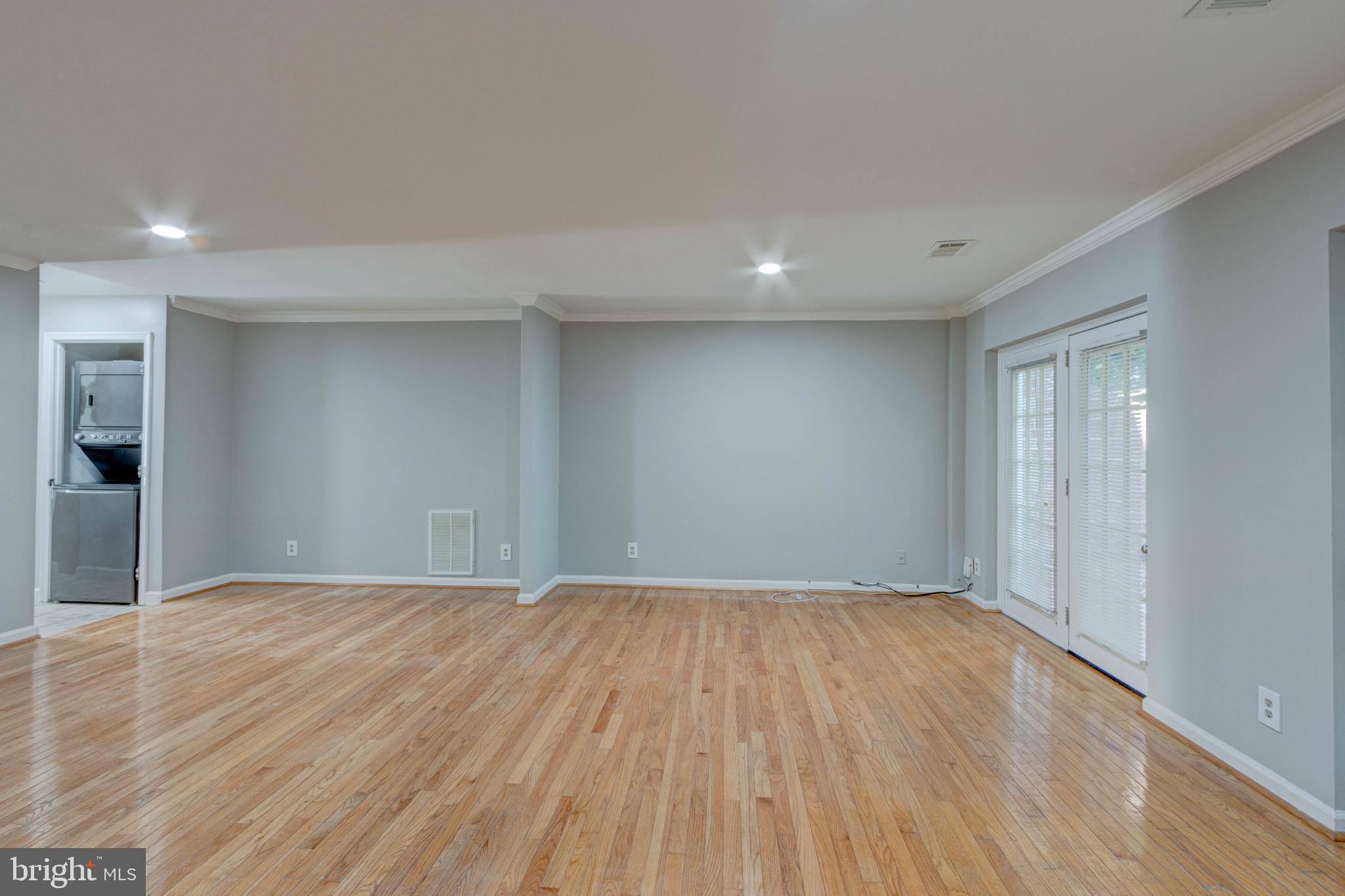 3934 Chesterwood Drive, Unit 3934 Silver Spring, MD 20906 - Photo 12 of 26 a view of an empty room with wooden floor and a window