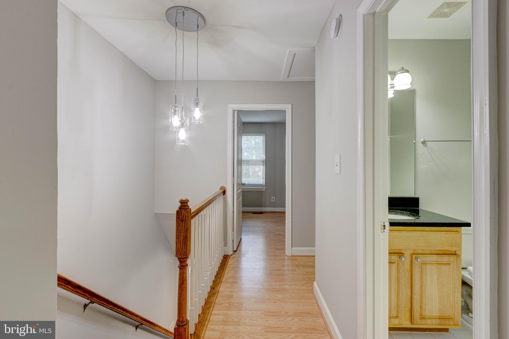 3934 Chesterwood Drive, Unit 3934 Silver Spring, MD 20906 - Photo 14 of 26 a view of a hallway with wooden floor and staircase