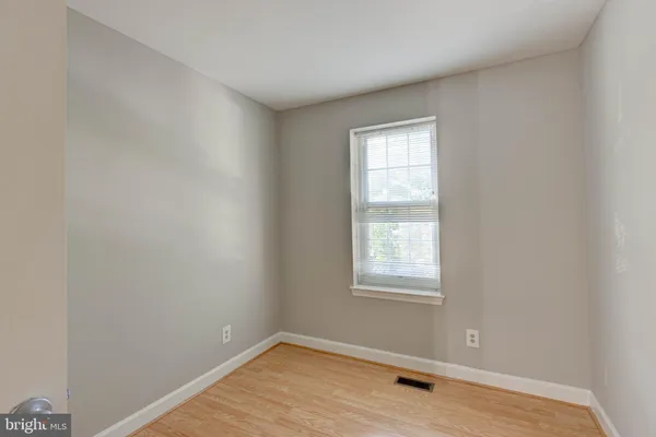 a view of a room with wooden floor and window