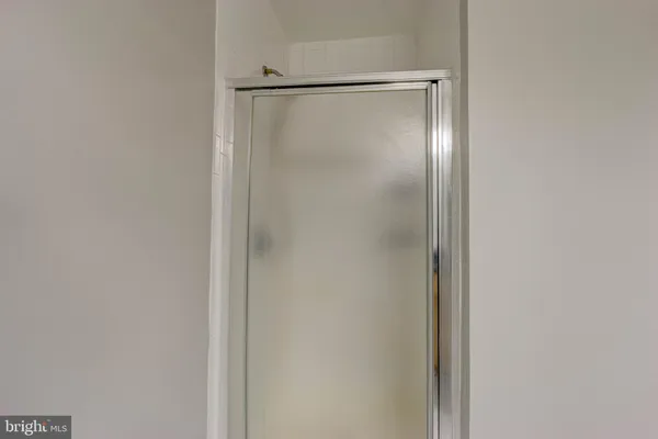 a bathroom with a glass shower door