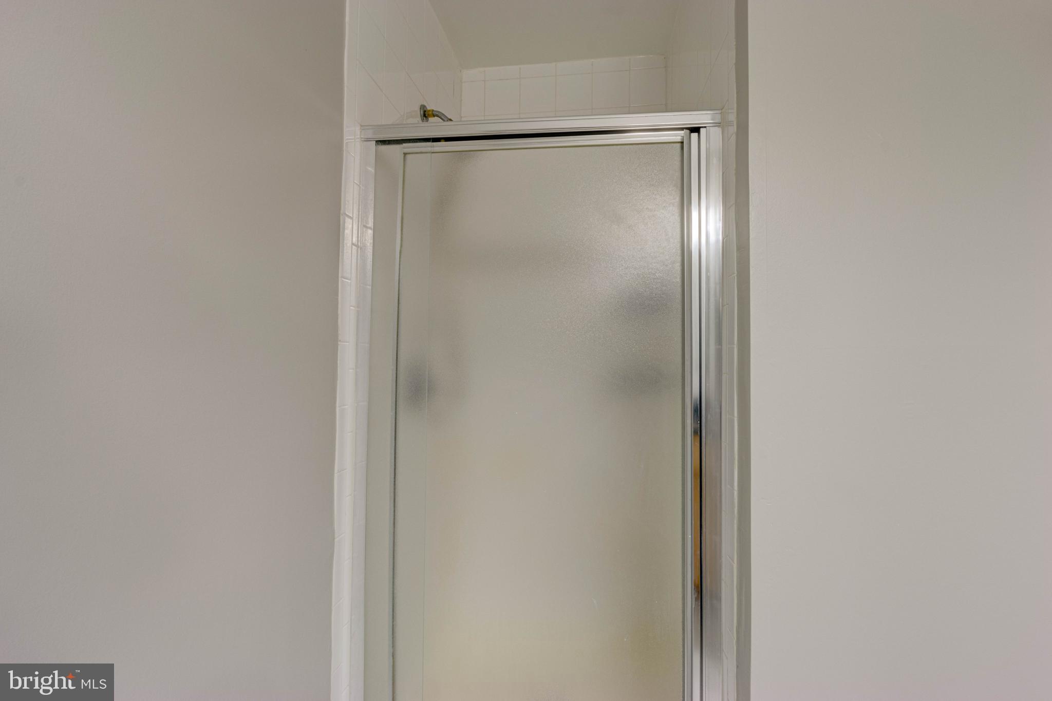 3934 Chesterwood Drive, Unit 3934 Silver Spring, MD 20906 - Photo 19 of 26 a bathroom with a glass shower door