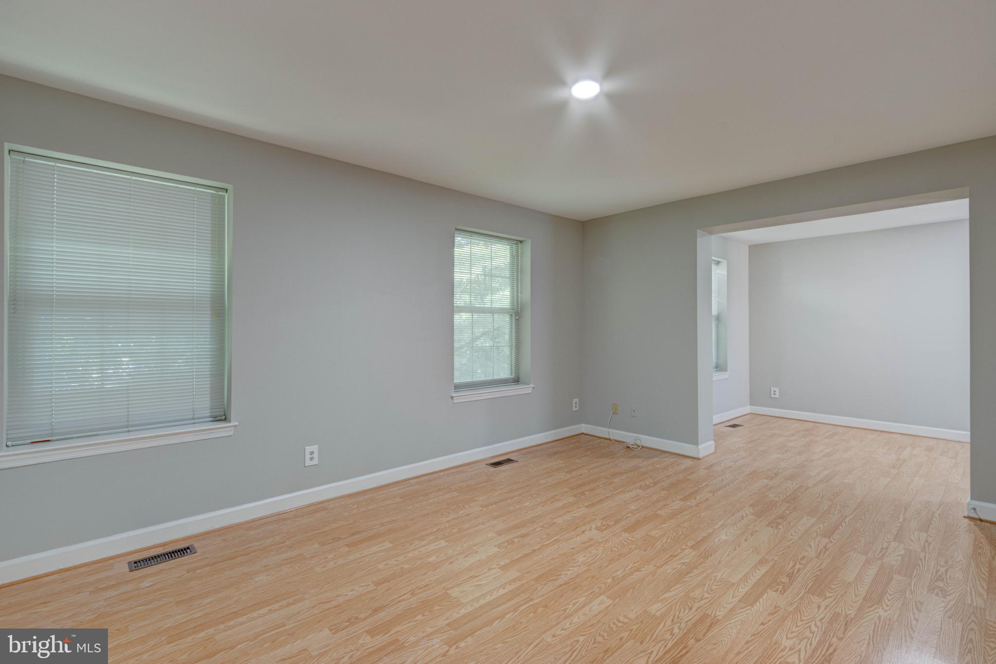 3934 Chesterwood Drive, Unit 3934 Silver Spring, MD 20906 - Photo 20 of 26 a view of an empty room with wooden floor and a window