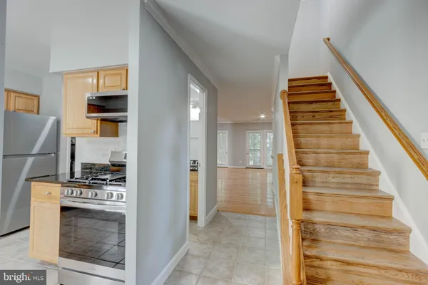 a view of kitchen and hallway with wooden floor