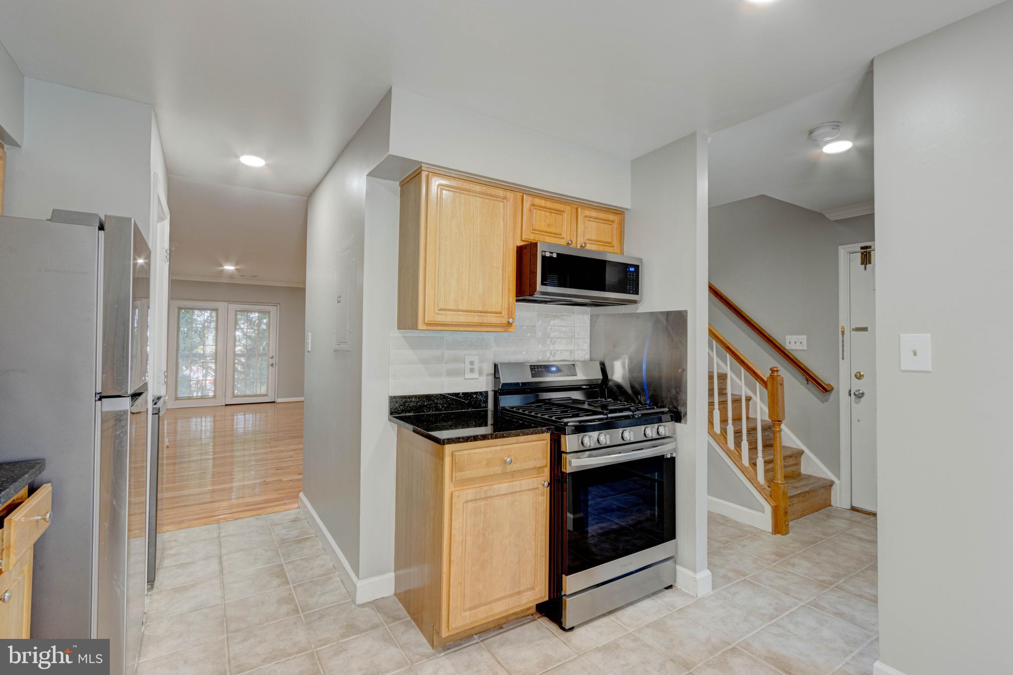 3934 Chesterwood Drive, Unit 3934 Silver Spring, MD 20906 - Photo 6 of 26 a kitchen with a stove a sink and a refrigerator