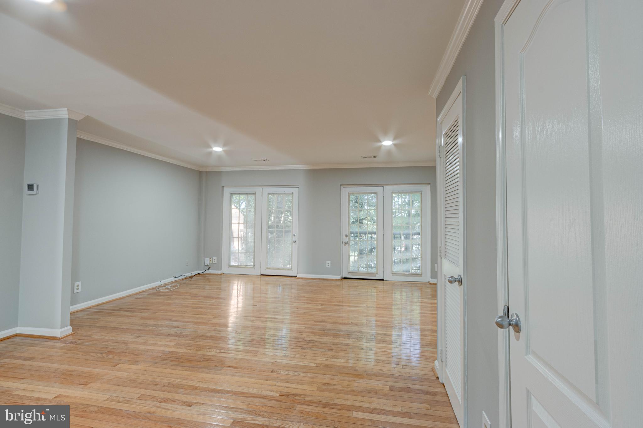 3934 Chesterwood Drive, Unit 3934 Silver Spring, MD 20906 - Photo 8 of 26 a view of an empty room with wooden floor and a window