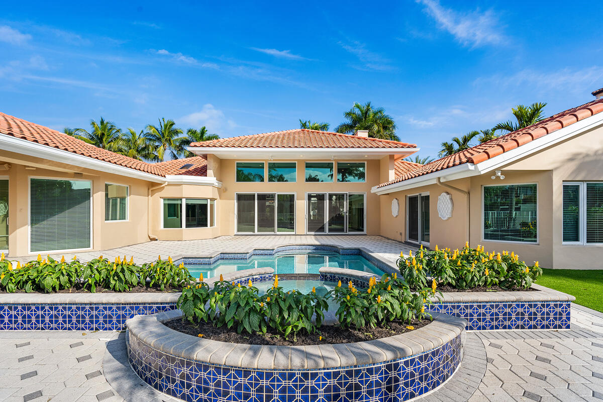 533 East Alexander Palm Road Boca Raton, FL 33432 - Photo 6 of 44 a front view of a house with a garden