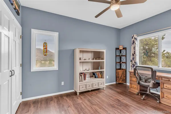 a bedroom with a bed a dresser and window