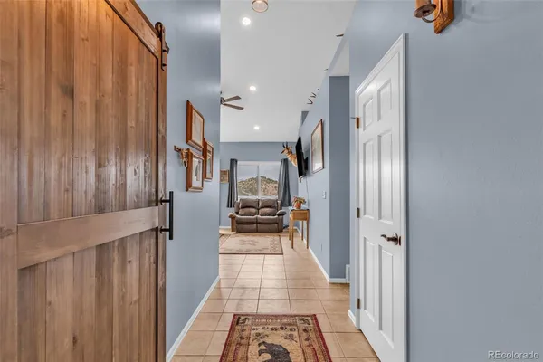 a hallway with a white stove top oven and refrigerator
