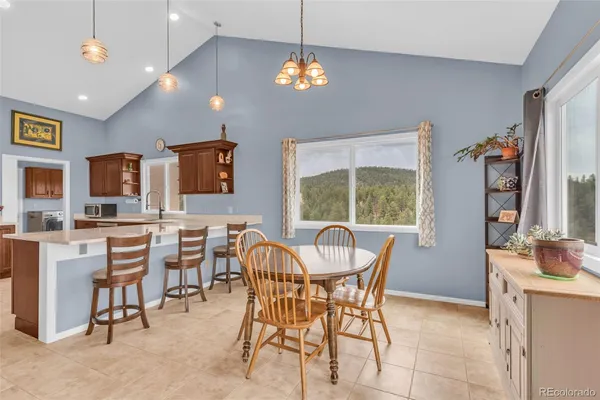 a dining room with furniture and window