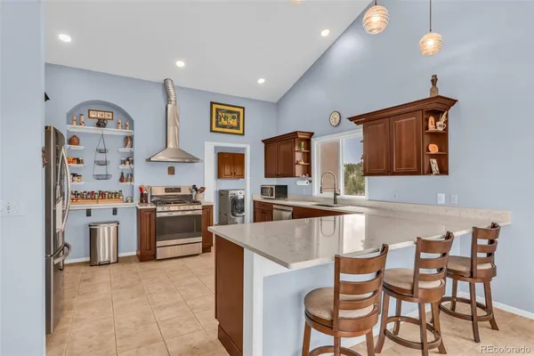 a kitchen with stainless steel appliances granite countertop a stove and a refrigerator