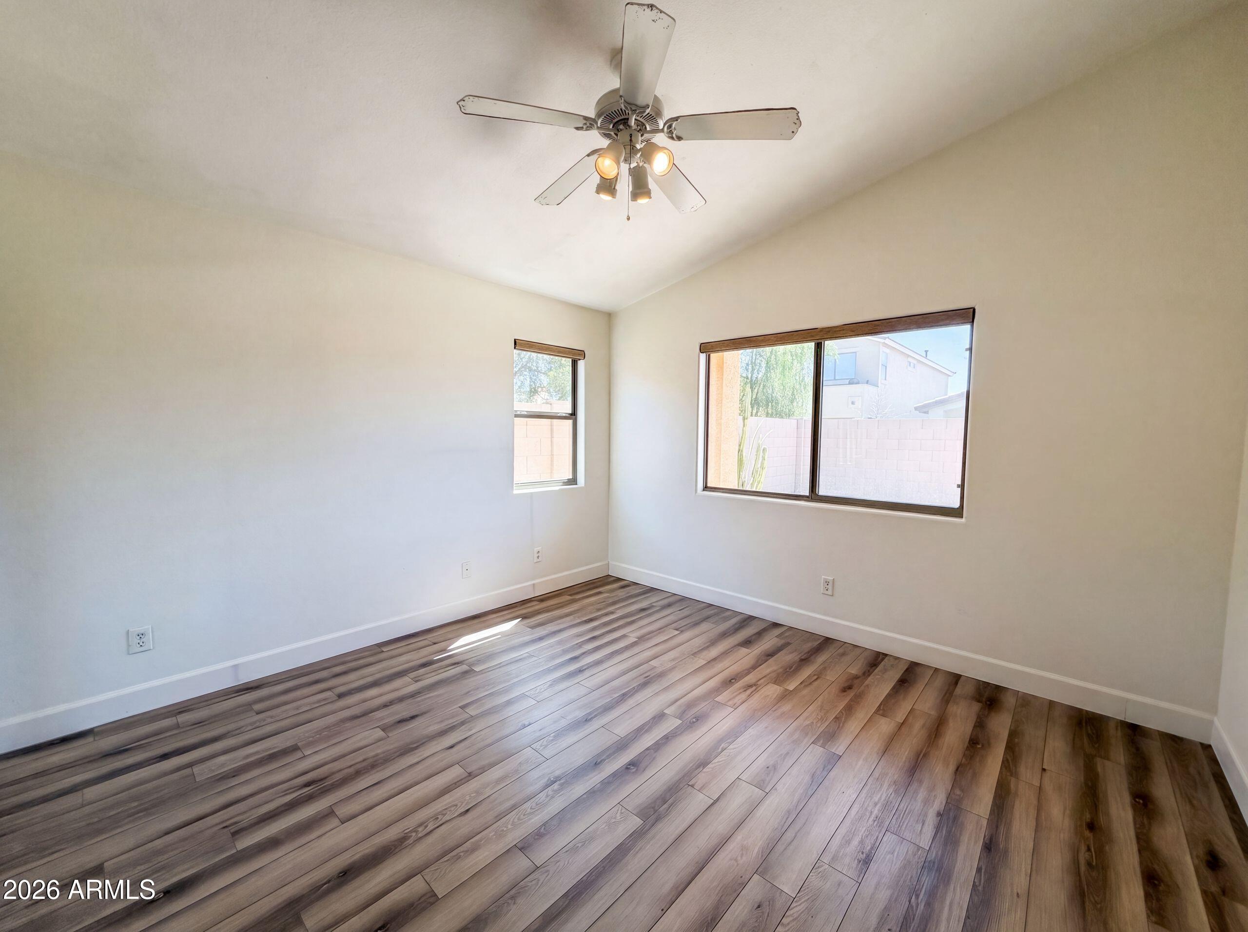 3951 East Timberline Road Gilbert, AZ 85297 - Photo 4 of 28 a view of an empty room with a window and wooden floor