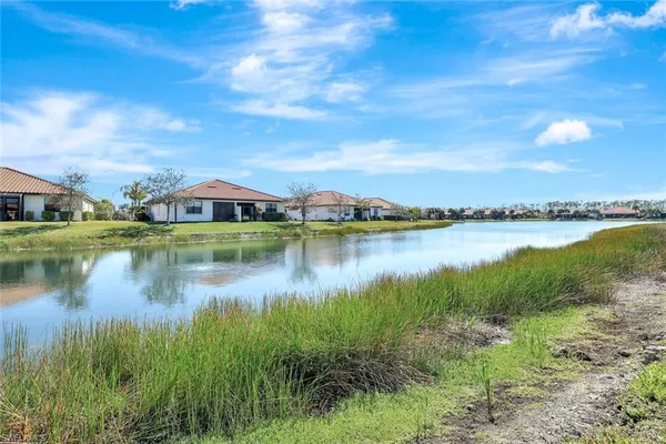 a view of a lake with houses in the back