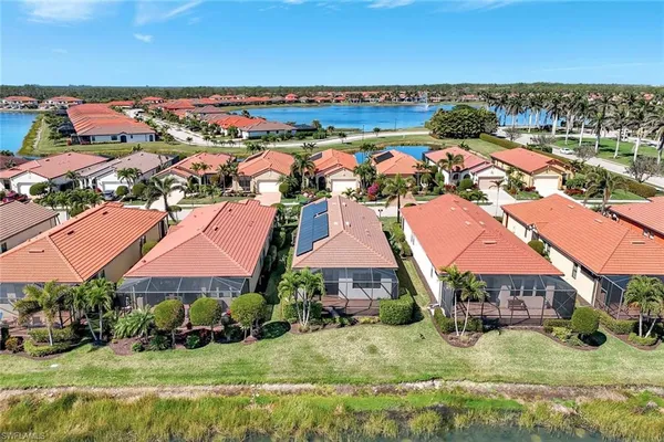 an aerial view of residential houses with yard and ocean view