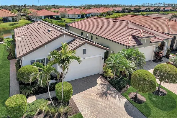 an aerial view of a house with a yard and furniture
