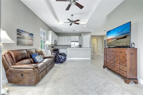 a living room with furniture a ceiling fan and a rug