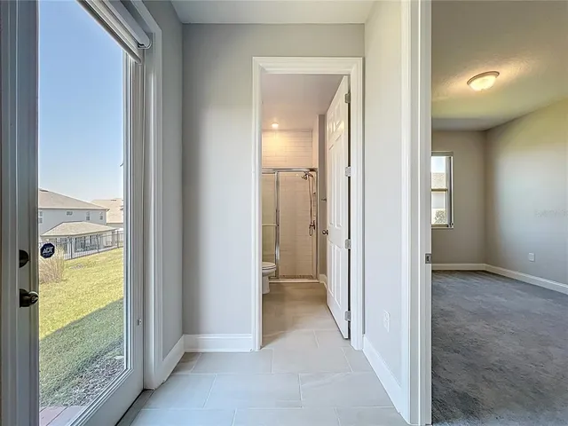 a view of kitchen with counter top space with windows